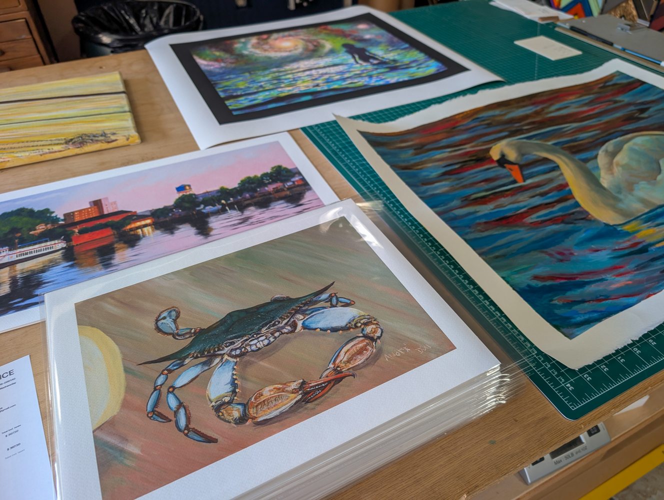 Fresh giclée prints laid out on the work table