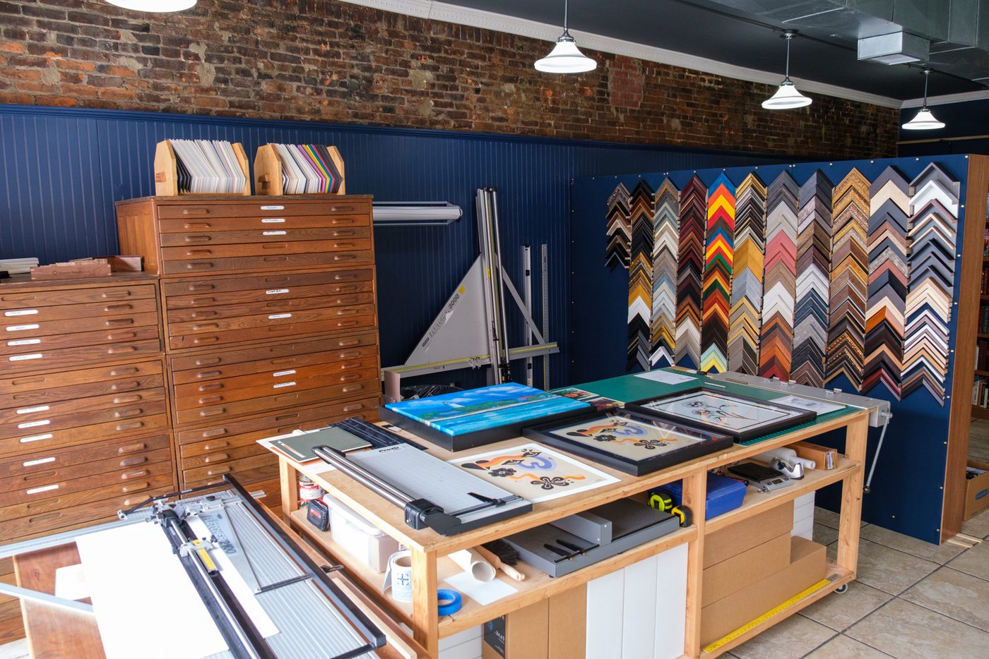 The Sail Away framing workspace with flat files and moulding wall